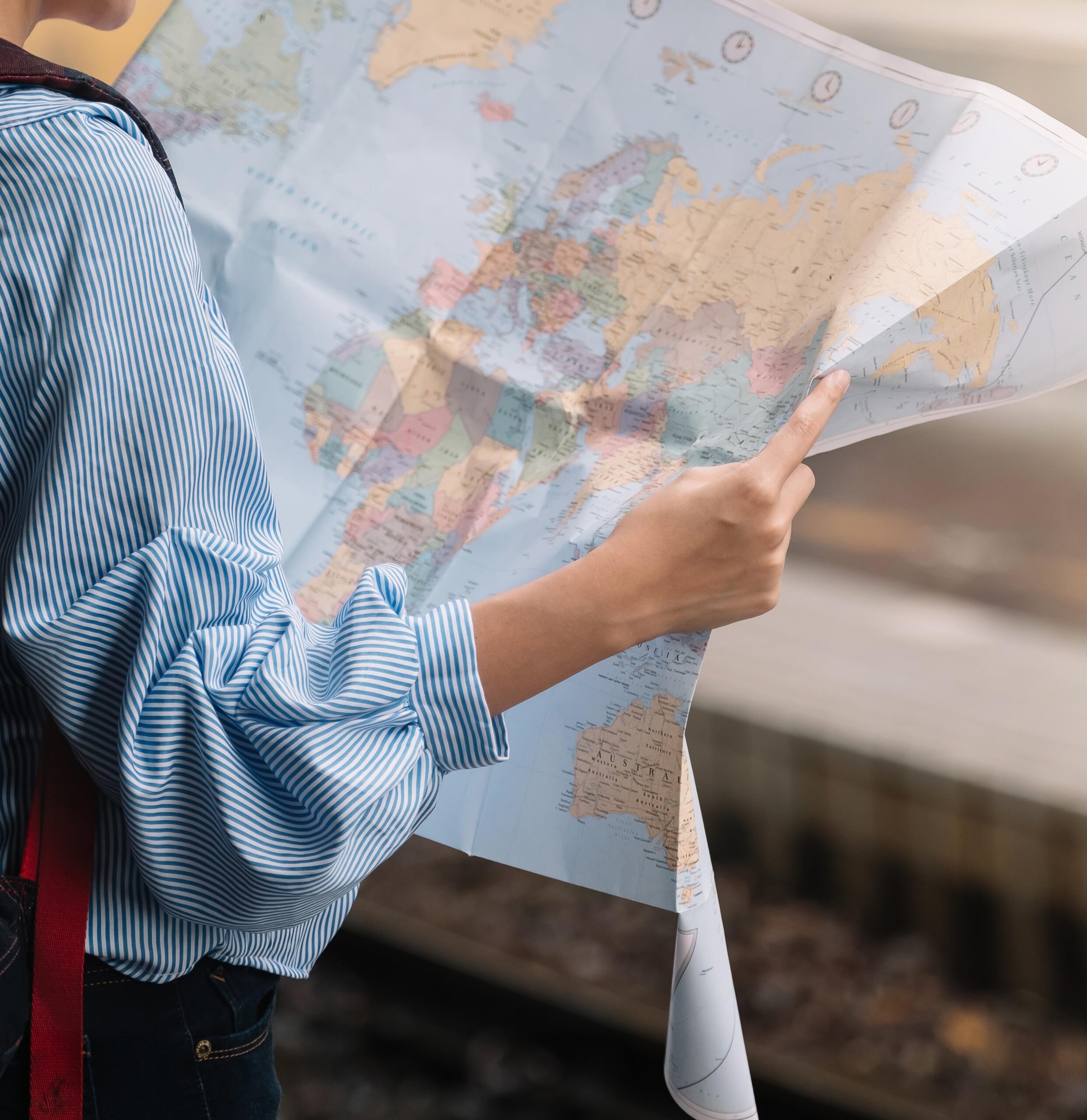 Shot of a young woman traveler or backpacker using map choose where to travel at train, Travel Concept
