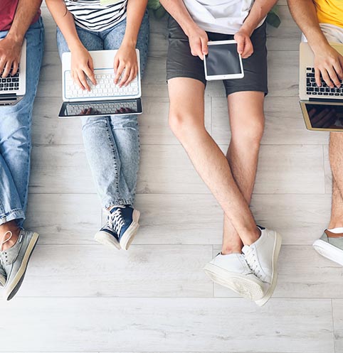 Students with modern devices studying online indoors